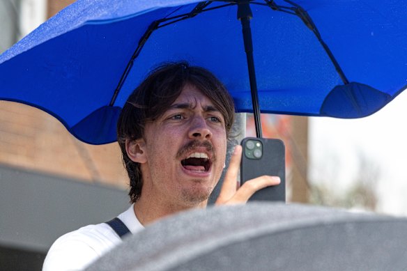 A man yells out as Israeli President Isaac Herzog is driven away from Bondi Pavilion.