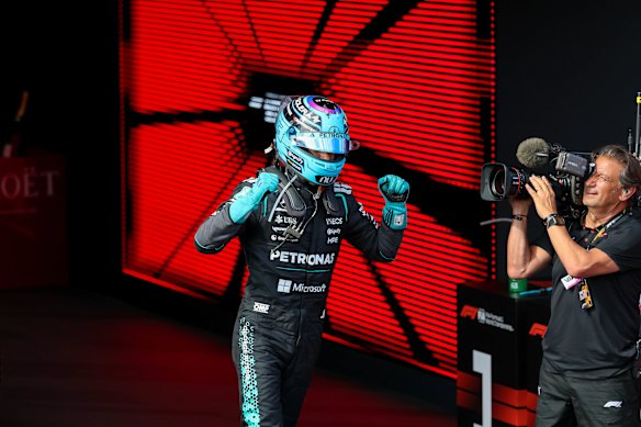 George Russell raises his fists in victory.