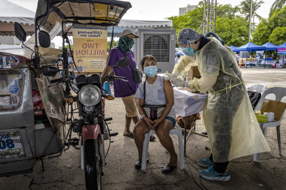 A public transportation worker is inoculated with Sinovac Biotech’s COVID-19 vaccine in Manila in 2021.