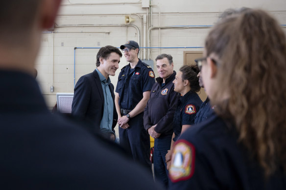 Canadian Prime Minister Justin Trudeau meets firefighters in Nova Scotia. Canada has endured a Black Summer of wildfires this year.