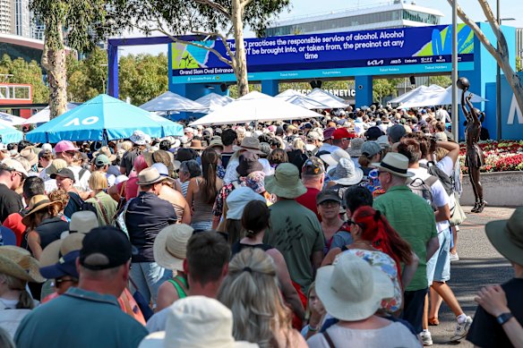 Tennis fans wait to enter the complex on Monday.