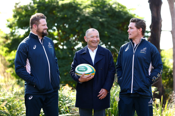 Wallabies head coach Eddie Jones flanked by former co-captains James Slipper and Michael Hooper in June.