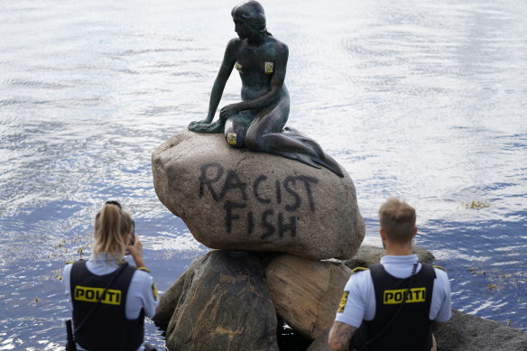 Police stand by the statue after another attack by vandals in 2020.