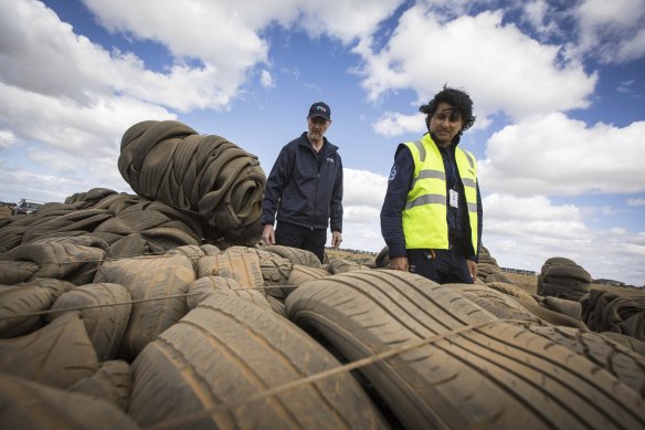 EPA investigators Greg Elms and Arun Baskaran inspect a freshly dumped cluster of baled tyres in Truganina.