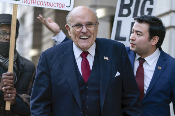 Former mayor of New York Rudy Giuliani walks to speak to the media outside the federal courthouse in Washington.