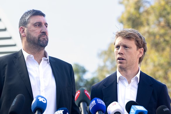 Swans coach Dean Cox and captain Callum Mills address the media on Friday.
