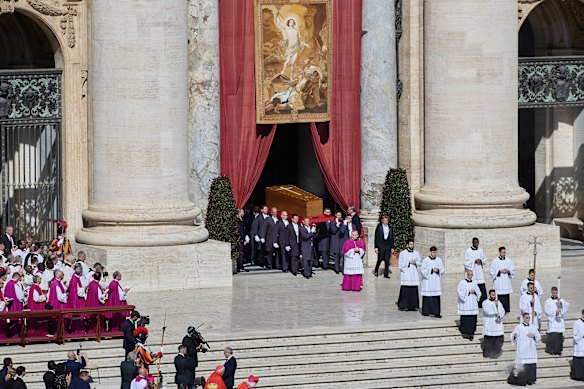 The Pope’s coffin is carried to the altar during the funeral ceremony.