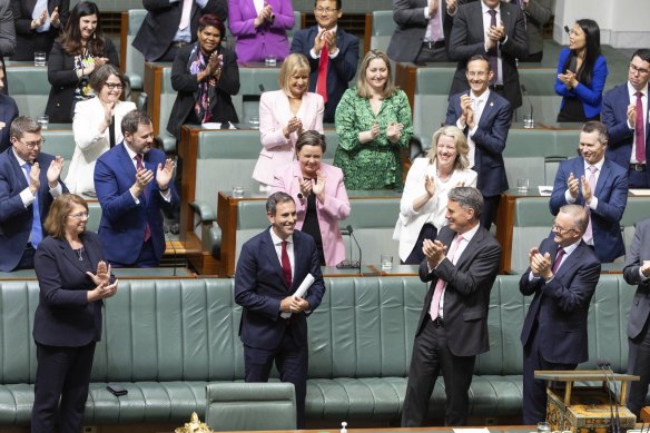 Treasurer Jim Chalmers is congratulated by colleagues after delivering the budget speech.