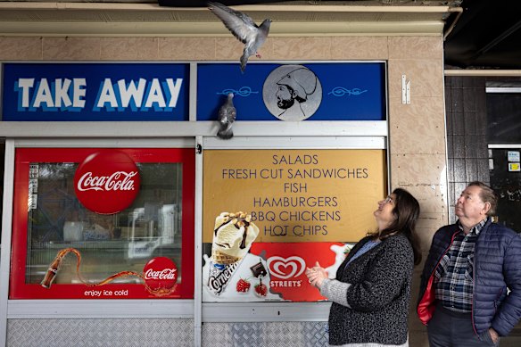 A pigeon flies towards Cumberland City councillors Helen Hughes and Paul Garrard at Dellwood shops in South Granville.