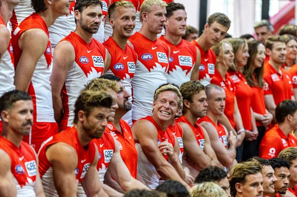 Isaac Heeney (centre) shares a laugh with his coach during a pre-season media day at Swans HQ in Moore Park.