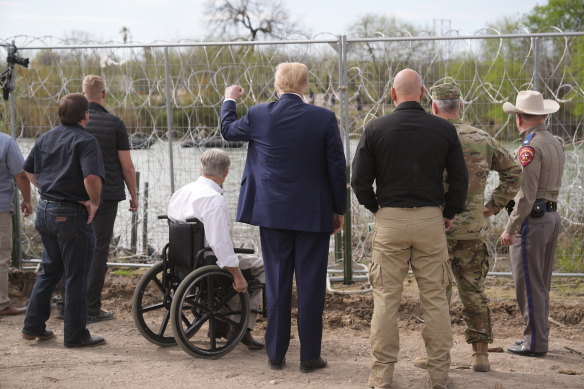 Republican presidential candidate Donald Trump gestures to people yelling from across the Rio Grande in Mexico as he visits the border in Eagle Pass, Texas, last month.