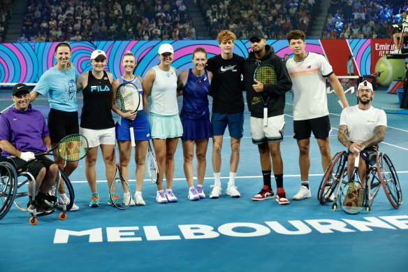 Ash Barty (third from left) and Iga Swiatek (fifth from left) at Rod Laver Arena on Friday.