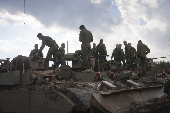 Israeli soldiers on armoured vehicles outside near the Lebanese border in upper Galilee on Thursday.
