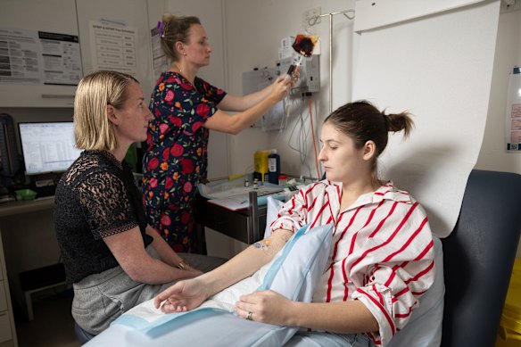 Abbey Whitaker (right) receives an iron transfusion from Dr Rebekah Hoffman (left) and registered nurse Sigrid Clift at Hoffman’s Kirrawee practice.