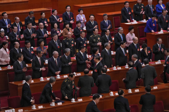 Xi Jinping (centre) and Premier Li Qiang (to his right) leave the hall at the end of Monday’s National People’s Congress.