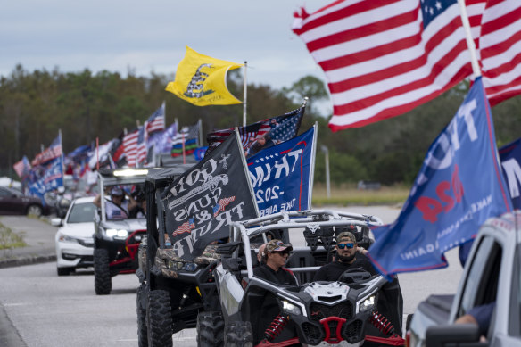 Supporters of President-elect Donald Trump participate in a victory parade on Sunday.