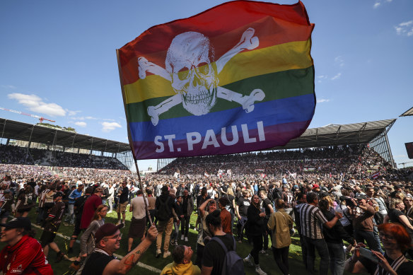 St. Pauli’s fans invade the field after their team won a match in Hamburg in May.