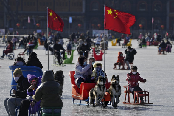 Out of lockdown: Beijing residents enjoy a sunny day on the frozen Houhai Lake on Monday.