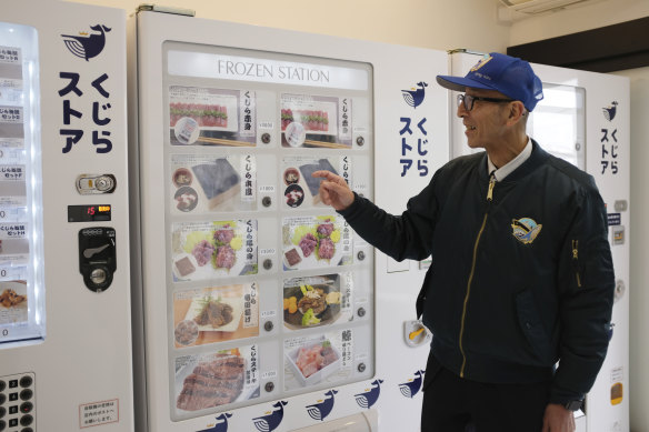 A spokesperson for Kyodo Senpaku with one of the company’s new whale meat vending machines.
