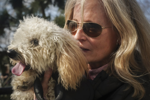 Colleen Briggs cuddles her eight-month-old poodle named Bondi, during a walk at a park near their home in New York.