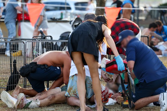 Members of the public help some of the wounded at Bondi Beach.