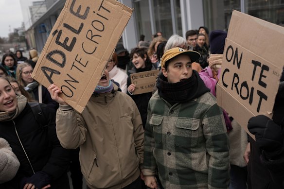 Protesters hold signs saying “Adele, we believe you” at a rally supporting Adele Haenel outside Paris Courthouse on Monday.