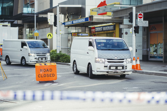 White vans drive out from the scene holding the bodies of victims.