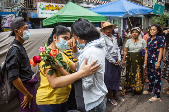 A student protester is welcomed home with flowers after she is released from prison. 