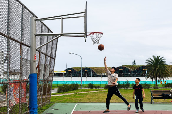 Members of Hualien’s indigenous community play basketball next to an air base from where F-16 fighter jets regularly scramble when Chinese jets encroach on Taiwanese airspace.