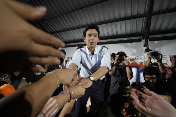 Former leader of Move Forward Party Pita Limjaroenrat (centre)  shakes hand with his supporters in Bangkok.