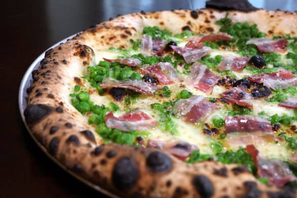 The piselli pizza merges pancetta, peas, mint, fior di latte and parmigiano.