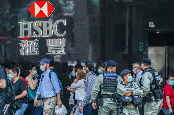 Riot police stand guard in front of an HSBC branch in Hong Kong's Central district on Friday. 
