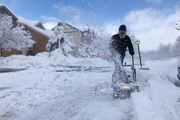 Snow covers vehicles in a neighborhood in Bellemont, Arizona, USA.