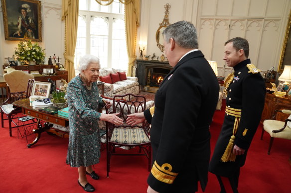 Queen Elizabeth speaking with Rear Admiral James Macleod (right) and Major General Eldon Millar – the incoming and outgoing defence service secretaries – at Windsor Castle on February 16