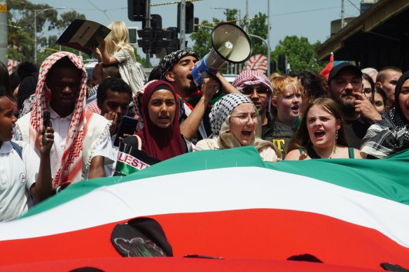 A crowd of students unfurled a watermelon flag in the Palestinian colours of red, white, black and green. 