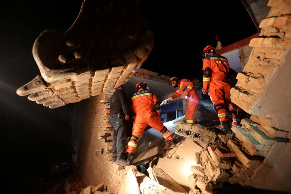 Workers conduct search and rescue operations at Kangdiao village following the earthquake in Jishishan county, Gansu province, China, on Tuesday.