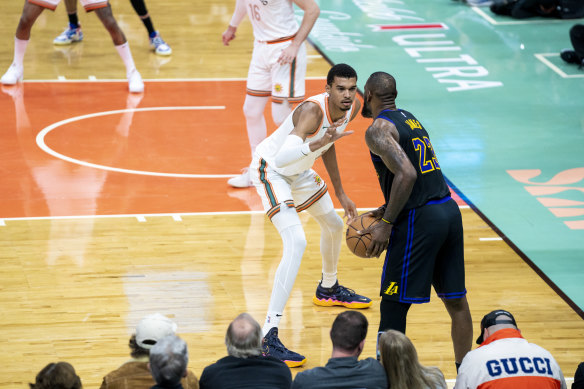 Victor Wembanyama squares off against LeBron James earlier in the NBA season.