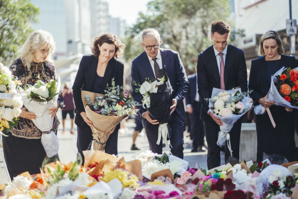 Minns laying flowers at the site of the attacks on Sunday alongside other politicians.