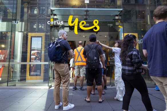 Customers line up outside an Optus shop front on George St during a country-wide network outage 