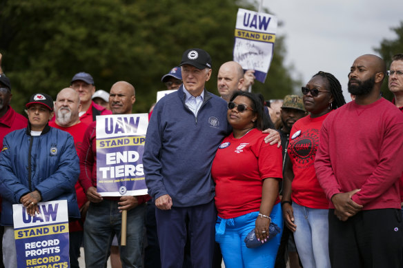 Joe Biden stands with striking car workers.