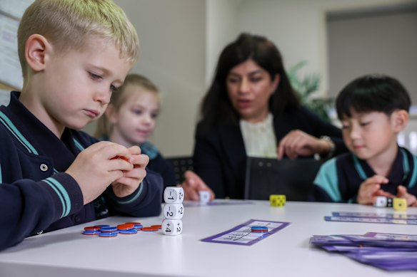 Maramba Primary School principal Moniba Ehsan and grade 1 students Quinn, Cara and Mason, who have completed new statewide numeracy checks. 