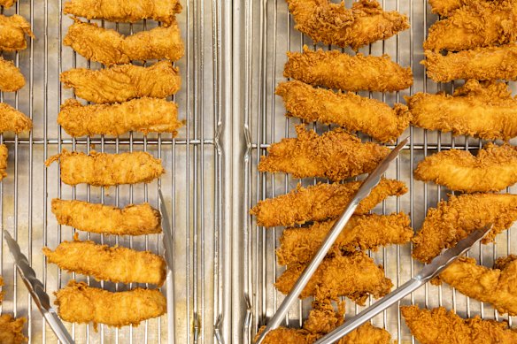 Old and new: KFC has relaunched chicken tenders that are 30 per cent bigger to keep up with competition.