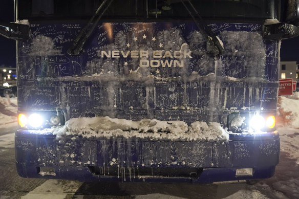 Ice and snow cover the bus of Republican presidential candidate Ron DeSantis outside a campaign event.