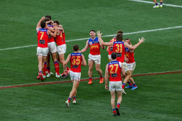 The Lions celebrate their victory.