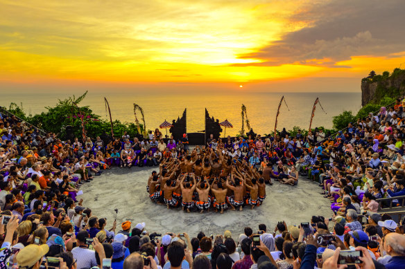 Tourists attend the Kecak Fire Dance ceremony in Bali.