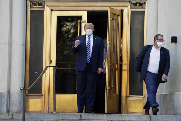 President Donald Trump walks out of Walter Reed National Military Medical Center to return to the White House on Monday.