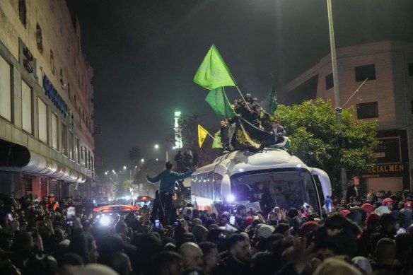 A bus carrying released Palestinian prisoners arrives in the West Bank city of Beitunia on Monday.