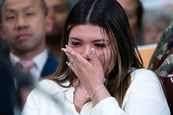 Garcia’s wife Jennifer Vasquez Sura wipes a tear from her face as Van Hollen speaks.