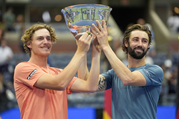 Max Purcell, left, and Jordan Thompson hold up the championship trophy.
