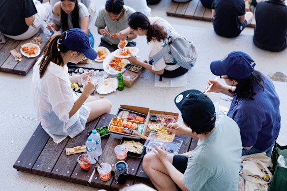 Families enjoy lunch at the new fish market.